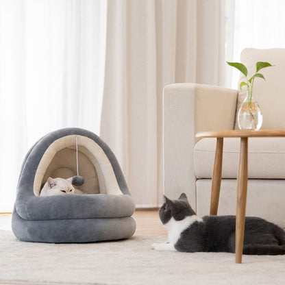 Beige-gray PurrFusion bed with cat cuddling in it and a cute cat lying in front of it